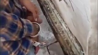 Indian pissing in public toilet